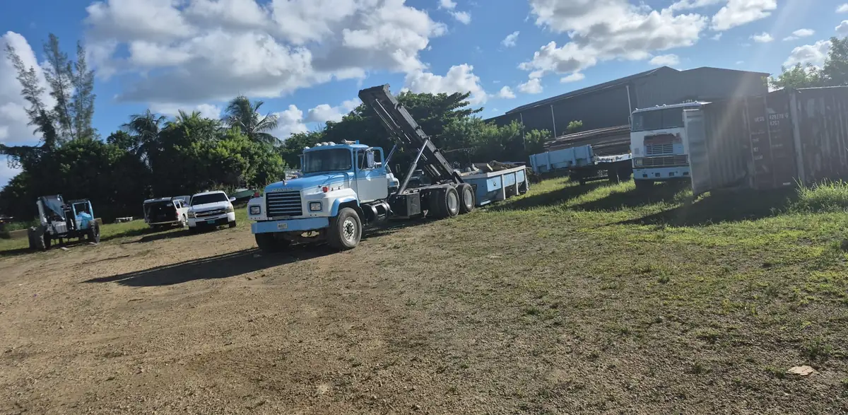 Overtime Mack roll-off truck with bed raised at the Nassau yard